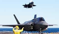 An Aviation Boatswains Mate maneuvers BF-04 (front), a Joint Strike Fighter F-35B Lighting II test plane after a vertical landing, as a second test plane BF-02 (back), approaches the flight deck for landing on the amphibious assault ship USS Wasp (LHD 1) during sea trials Истребитель 5-го поколения